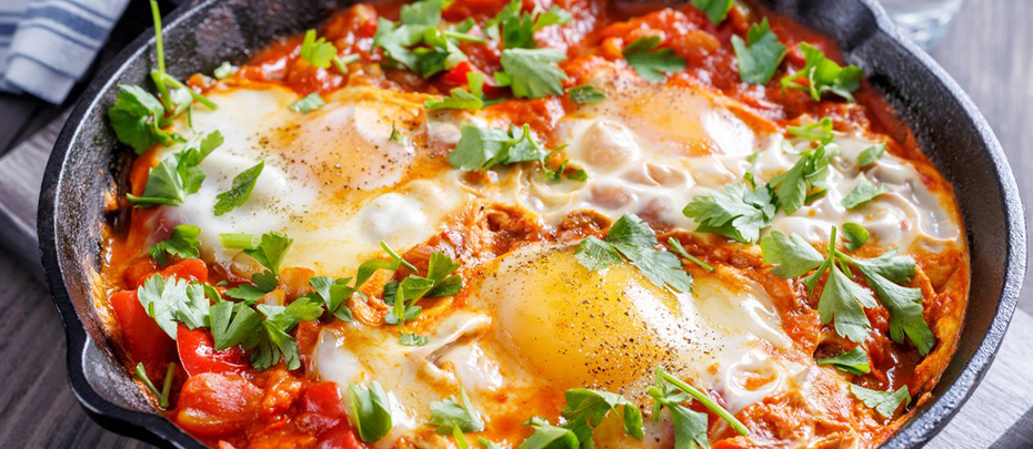 A skillet with protein-rich eggs in tomato sauce.