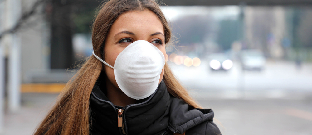 Woman wearing face mask protective spreading flu disease virus, protection against influenza viruses and diseases. Girl wearing mask on face in public spaces because of air pollution and particulates.; Shutterstock ID 1628718772; PO: 123