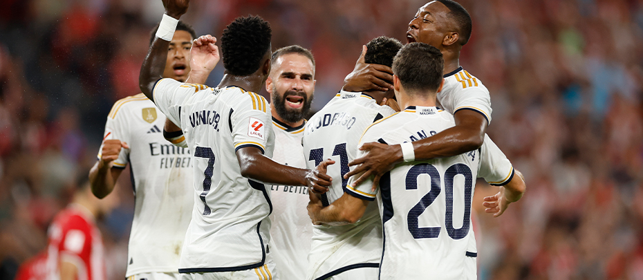 Six Real Madrid soccer players hug and celebrate