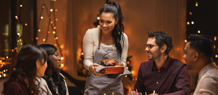 A group of friends enjoy a holiday meal together.