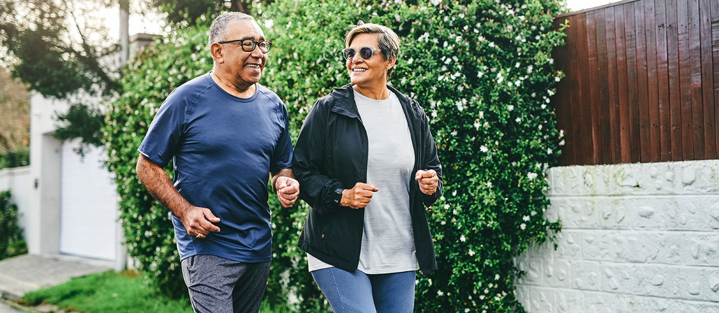 Two people jogging outside.